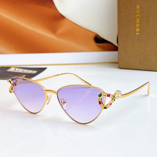 Gold cat-eye glasses with purple lenses and multicolor jeweled bridge
