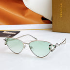 Silver cat-eye glasses with light green lenses and multicolor jeweled bridge