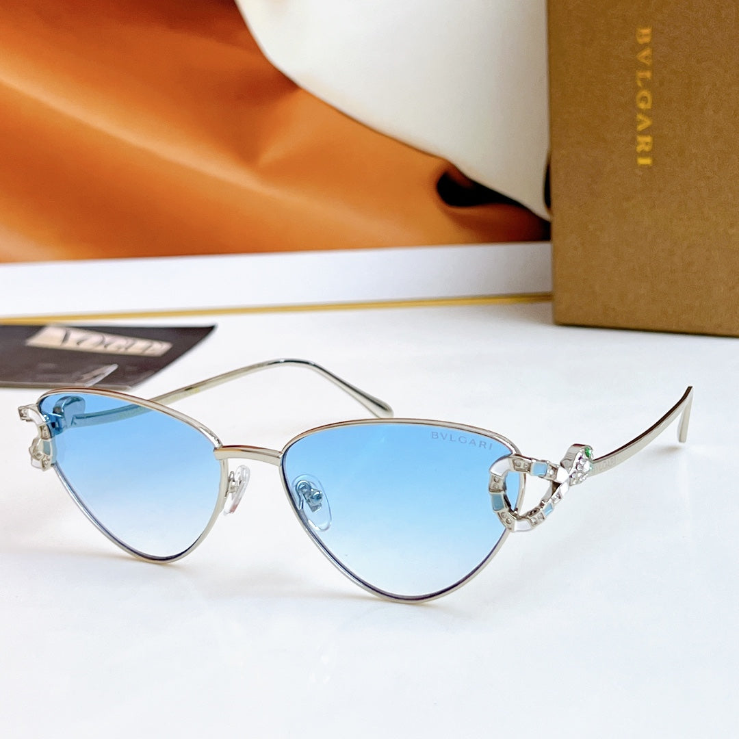 Silver cat-eye glasses with light blue lenses and multicolor jeweled bridge