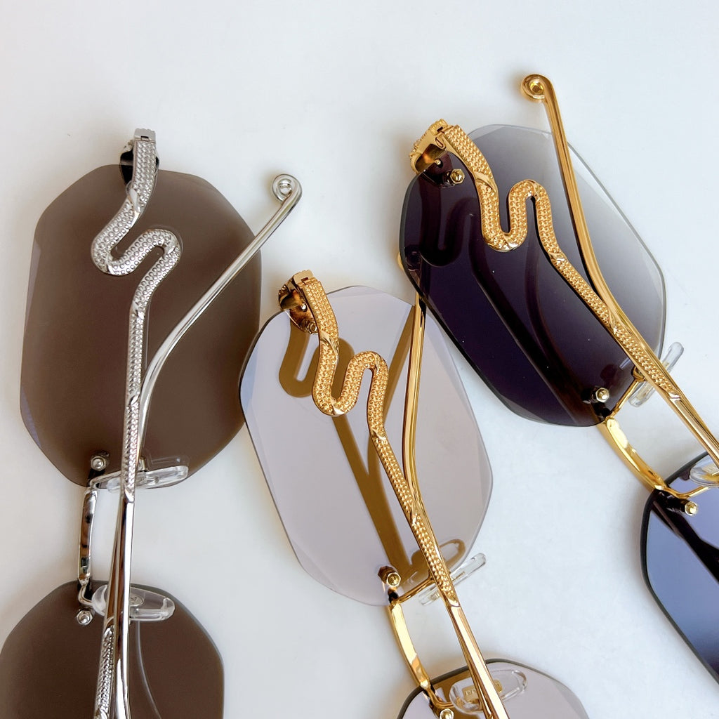 Bvlgari sunglasses with metal frames and mirrored lenses in silver, gold, and dark purple