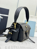 Black leather top-handle shoulder bag with gold-tone hardware and logo detail on flap