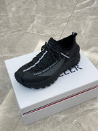 Black Moncler lace-up sneakers with grippy outsole and chunky design