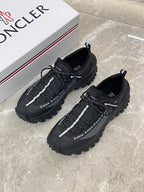 Black Moncler trail sneakers with lace-up and textured side panels
