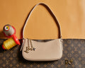 Louis Vuitton small hobo bag with beige leather and monogram canvas, chain charm