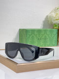 Gucci sunglasses with black oversized frames and dark tinted lenses, metal logo detail