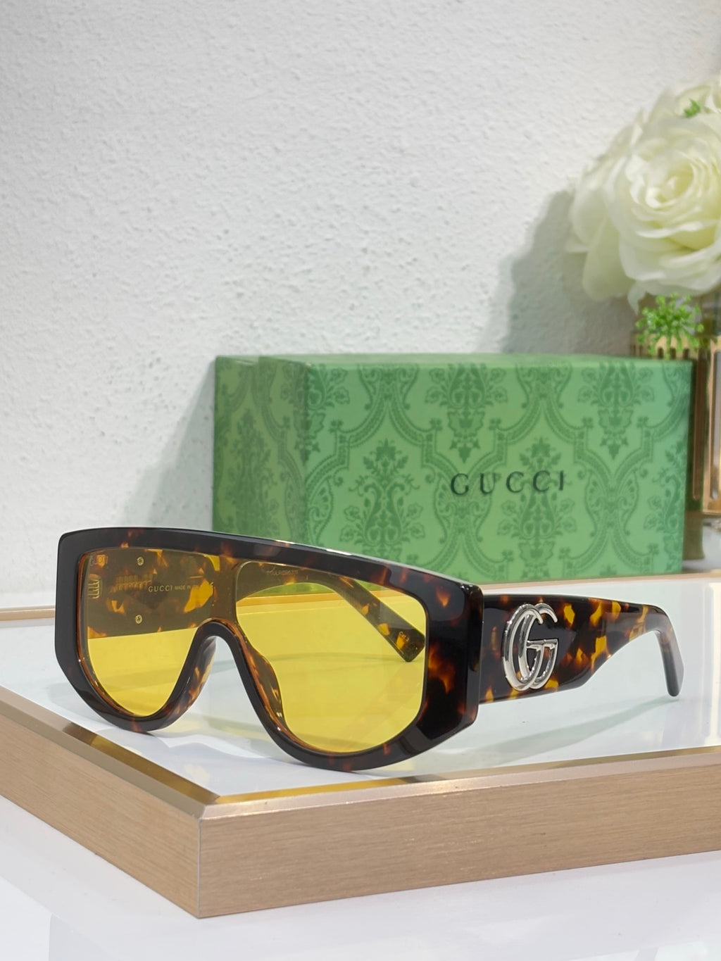 Gucci sunglasses with tortoiseshell oversized frames and amber tinted lenses, metal logo