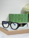 Gucci sunglasses with black frames, blue-tinted lenses, and gold GG logo on the temple.