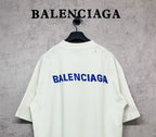 White short-sleeve T-shirt with blue Balenciaga logo on the back