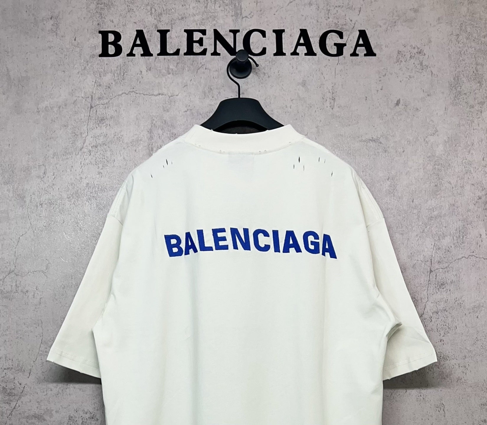 White short-sleeve T-shirt with blue Balenciaga logo on the back