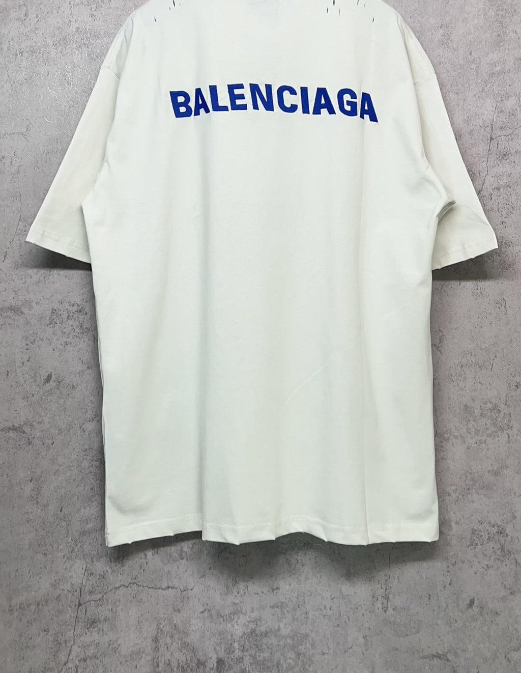 White short-sleeve T-shirt with large blue Balenciaga logo on the back