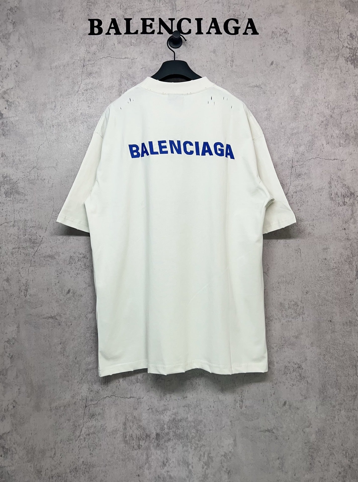 White short-sleeve T-shirt with blue Balenciaga logo on the back
