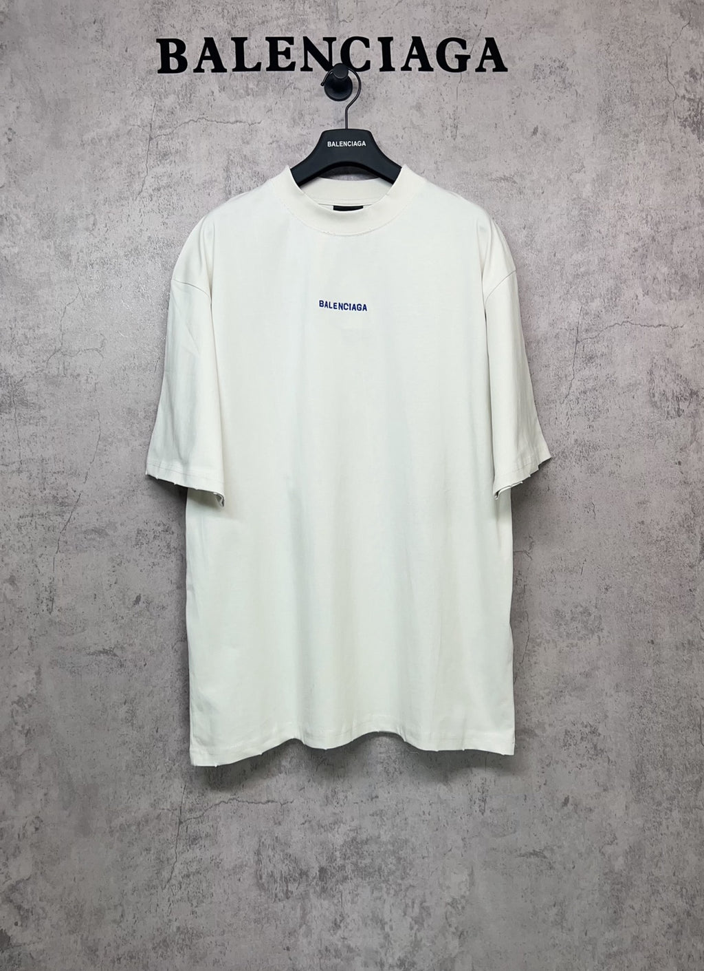 White short-sleeve T-shirt with small black Balenciaga logo on the chest