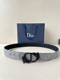 Belt with silver-gray textured strap and black ornate buckle