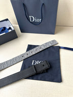Belt with silver-gray strap and black buckle, laid flat