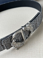 Dior logo-print belt close-up: silver-gray strap with metal buckle and bar clasp.