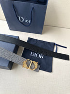 Dior belt strap with cut holes and gold-toned buckle hardware, flat on display.