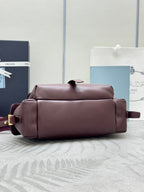 Burgundy Prada shoulder bag with top zipper and short strap, rectangular silhouette