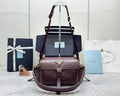 Burgundy Prada tote bag with top handles and detachable shoulder strap, gold hardware