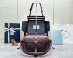 Burgundy Prada tote bag with top handles and detachable shoulder strap, gold hardware