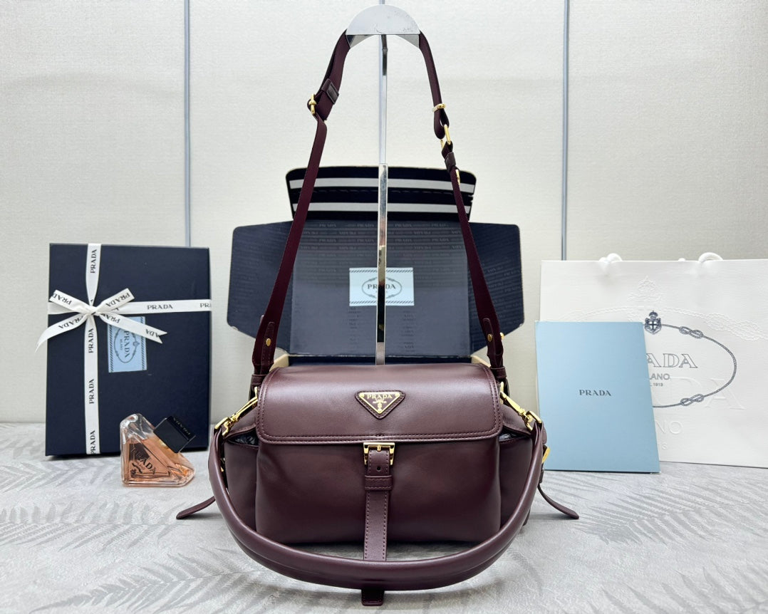 Burgundy Prada tote bag with top handles and detachable shoulder strap, gold hardware