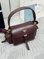 Burgundy Prada crossbody satchel with gold logo plate, flap front and shoulder strap