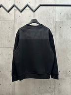 Black crew-neck sweatshirt with long sleeves on hanger