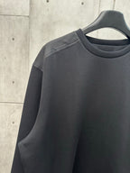 Black crew-neck sweatshirt with long sleeves and shoulder seam