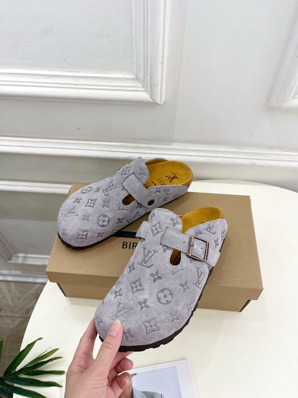 Monogram slide sandals in light gray, front view with adjustable strap and buckle
