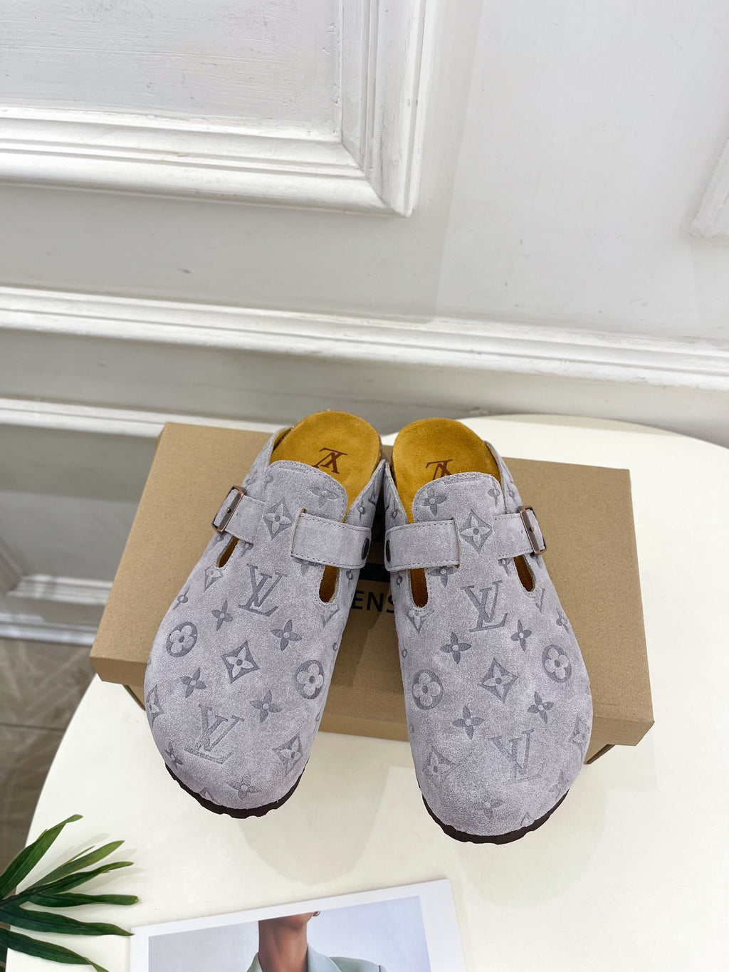 Monogram slide sandals in light gray with adjustable strap and metal buckle