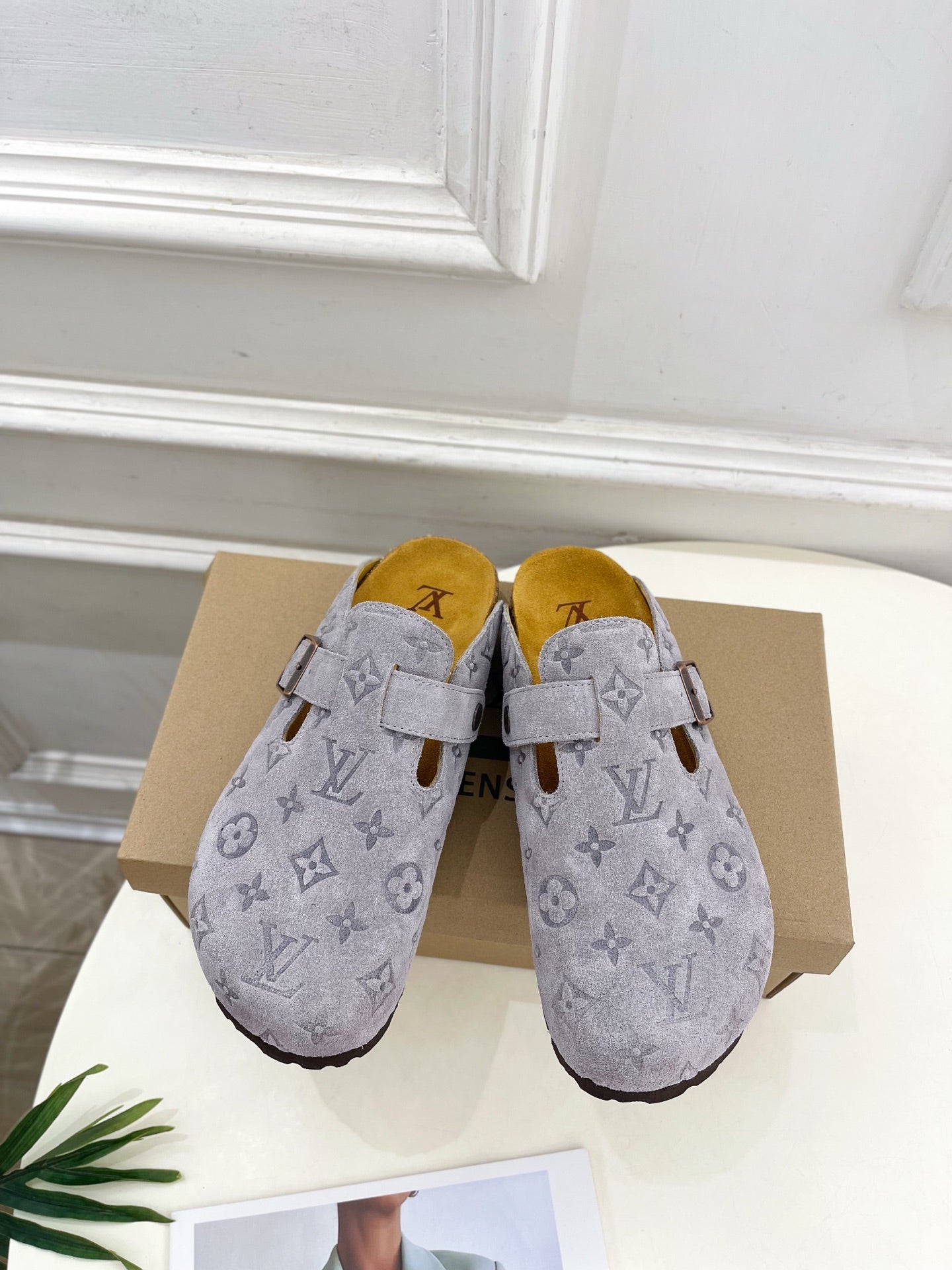 Monogram slide sandals in light gray with adjustable strap and metal buckle