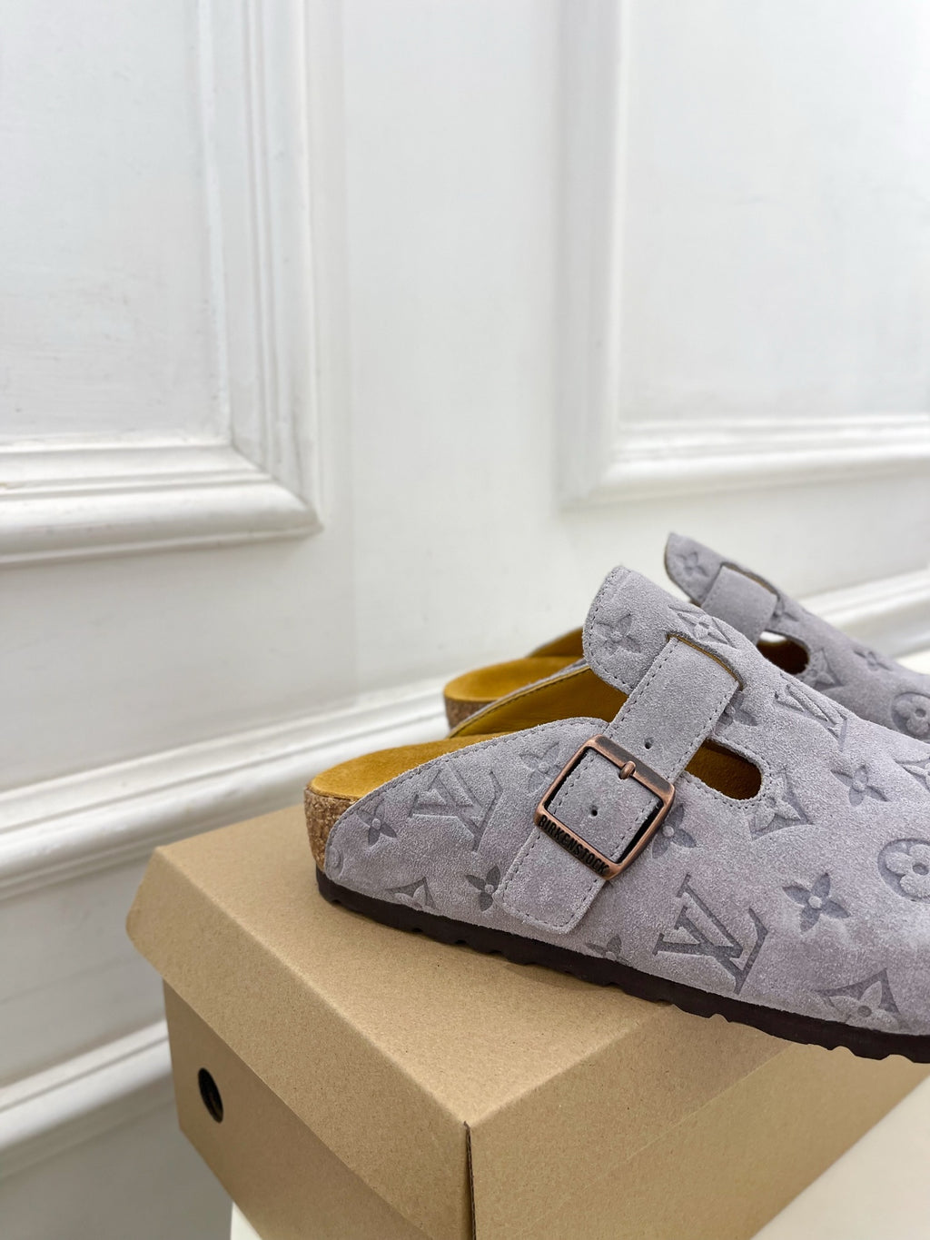 Monogram slide sandals in light gray with two straps and square metal buckles