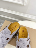 Monogram slide sandals in light gray with adjustable strap; tan interior footbed