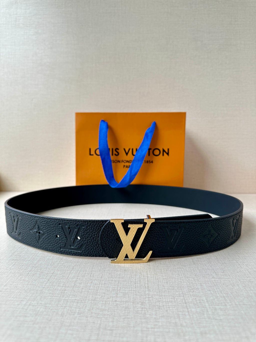 Louis Vuitton belt in dark blue leather with embossed pattern and gold-tone LV buckle