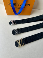 Louis Vuitton belt set laid out: dark leather straps with gold-tone LV buckles