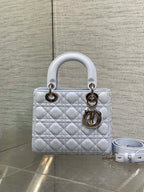 Quilted light blue Dior handbag with gold hardware and detachable shoulder strap