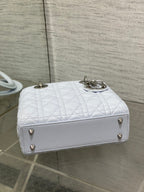 Dior quilted light blue handbag with flap closure, gold feet, and top handles