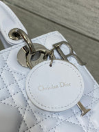 Dior handbag keychain charm and round logo tag on quilted light blue leather