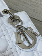 Dior handbag charm detail on quilted light blue leather with silver-toned hardware