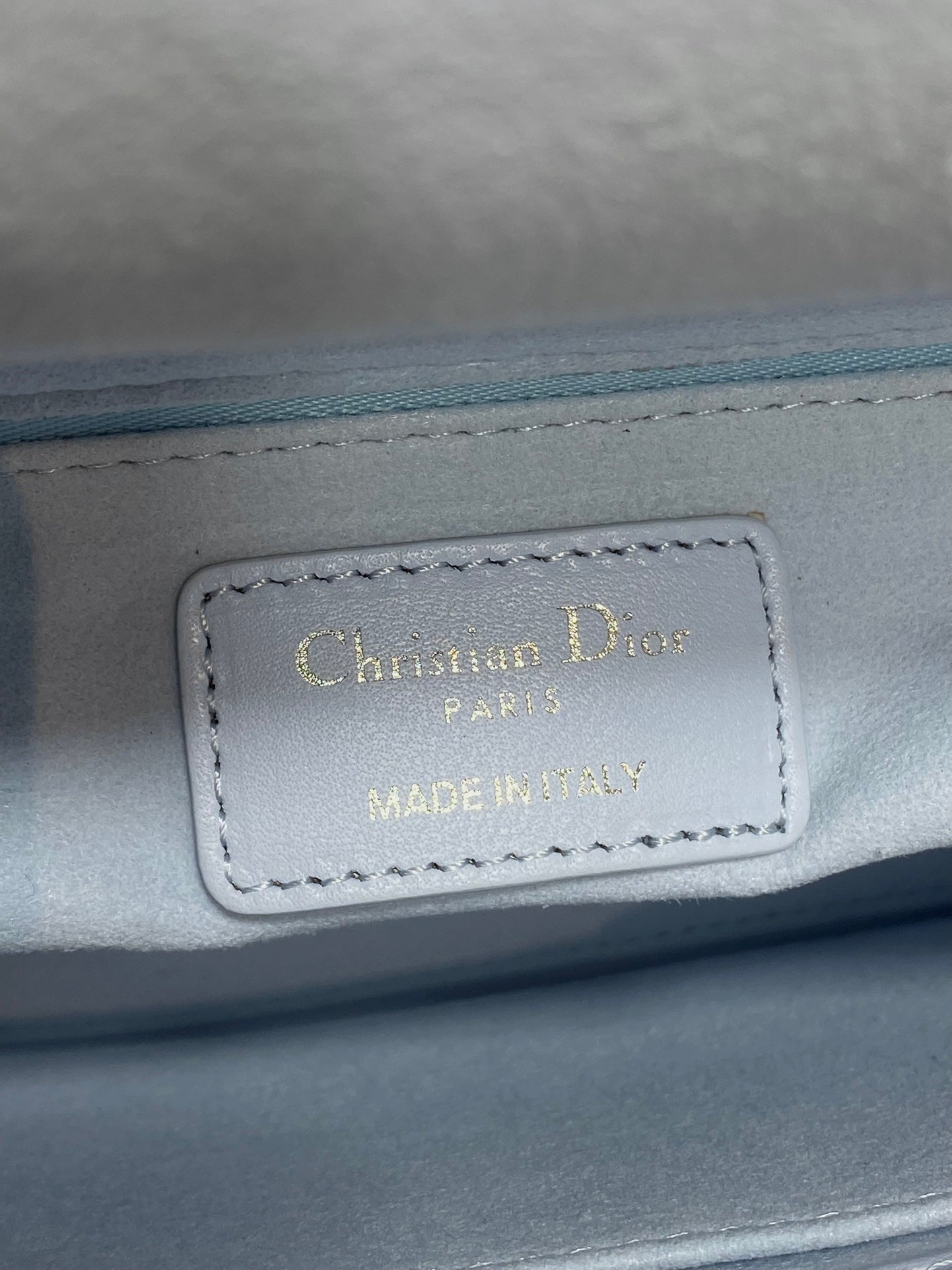 Dior logo leather label reading Christian Dior Paris, Made in... on handbag lining