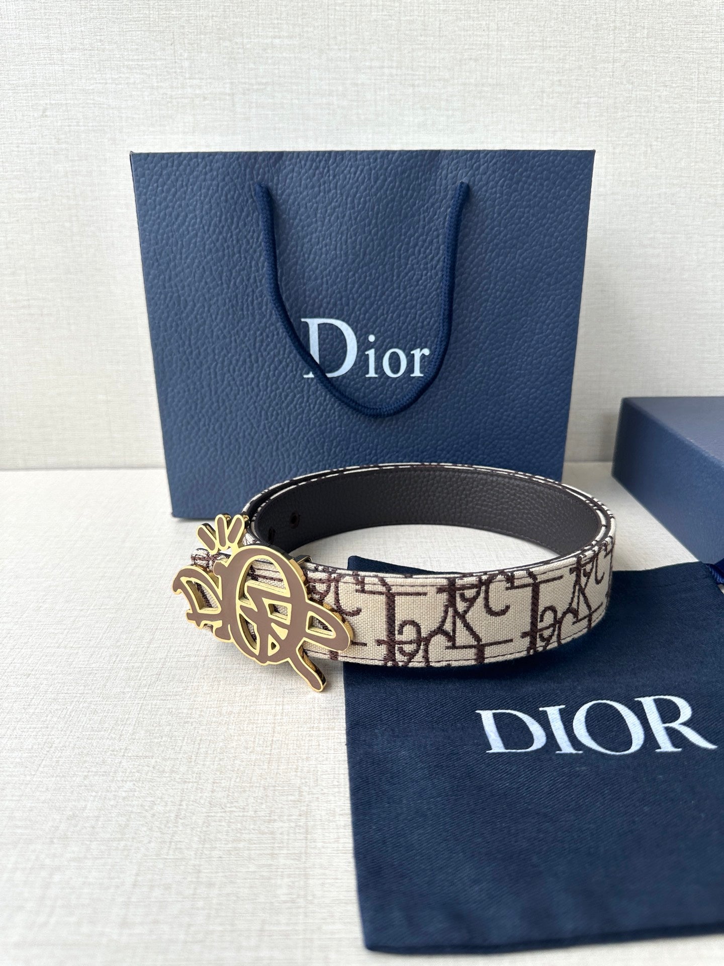 Dior belt with beige logo canvas strap and gold-toned emblem buckle
