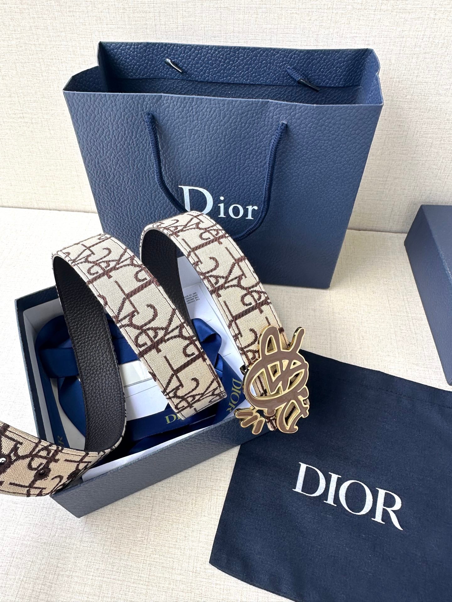 Dior belt with beige logo canvas strap and gold-toned Dior emblem buckle