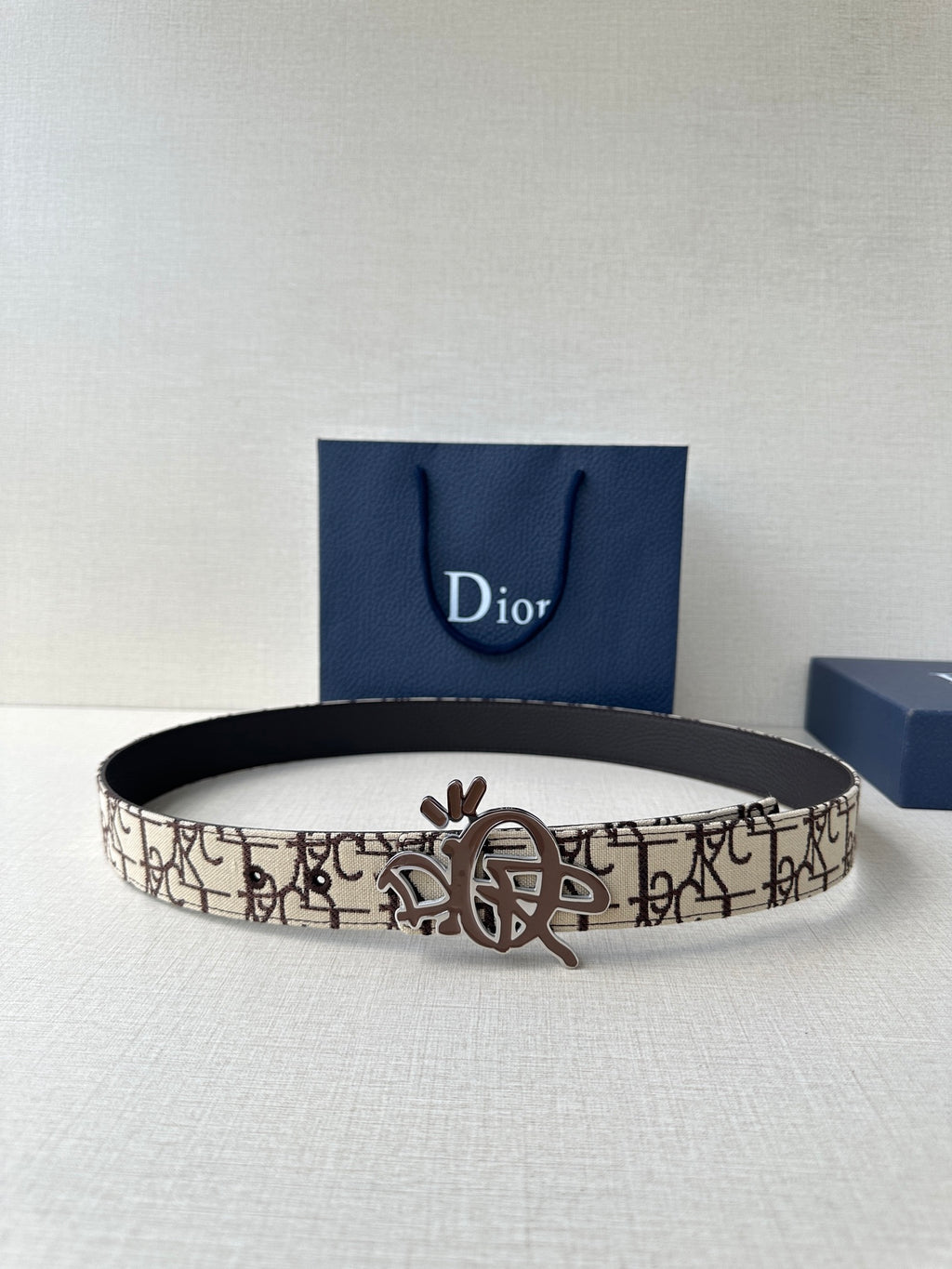 Dior belt with beige logo canvas strap, black inner edge, gold-toned clasp