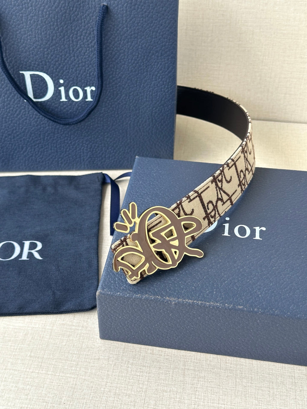 Dior belt with beige logo canvas strap and gold-toned emblem buckle