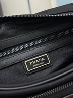 Prada bag interior side view with dual zippers and Prada logo label