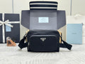 Prada bag, black crossbody with front flap, gold-tone hardware, adjustable strap