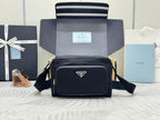 Prada bag, black crossbody with front flap, gold-tone hardware, adjustable strap