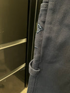 Dark blue denim cargo pants with angled side pocket and stitched seam detail