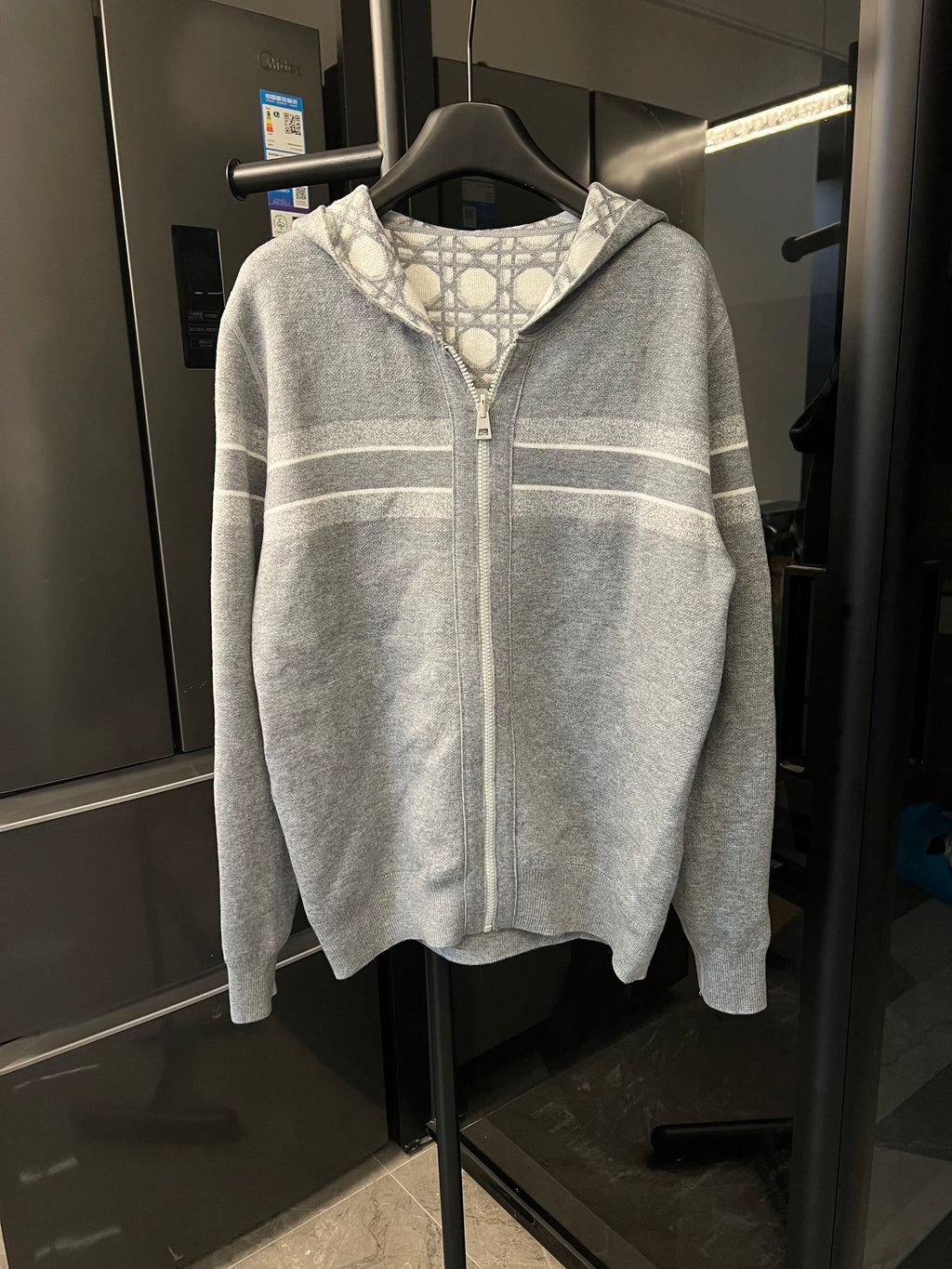 Grey zip-up hoodie with Dior monogram shoulder and chest stripe bands, front view