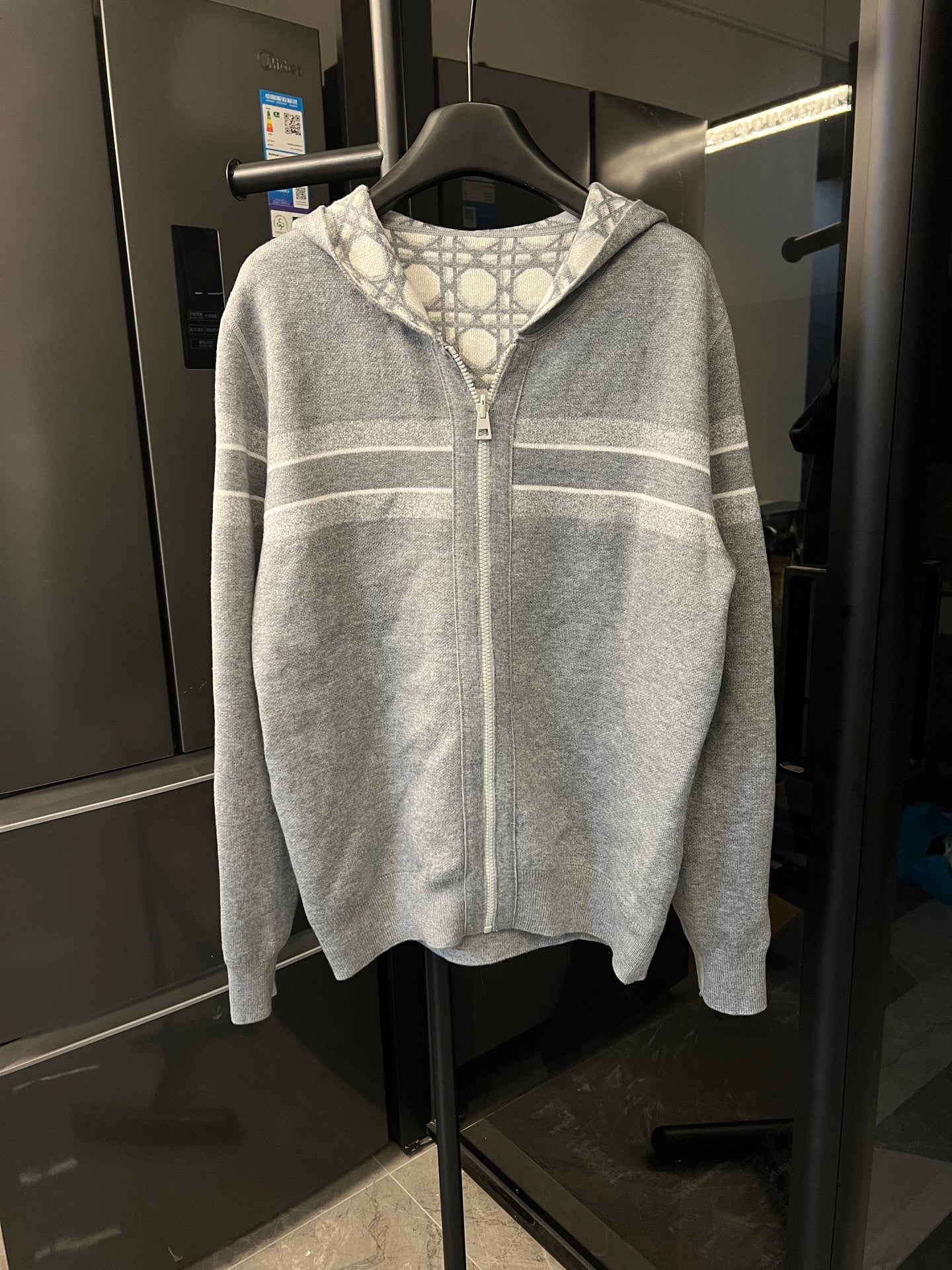 Grey zip-up hoodie with Dior monogram shoulder and chest stripe bands, front view