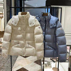 Moncler long hooded puffer jackets, white and light blue, hanging display